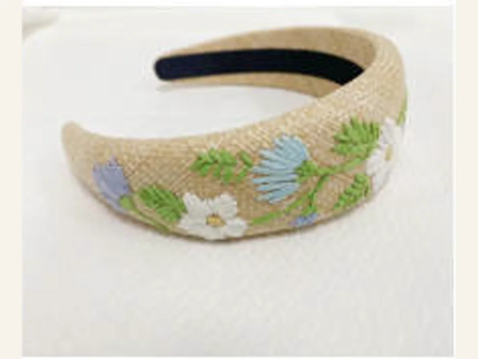 Cream padded headband with green and blue floral embroidery development sample