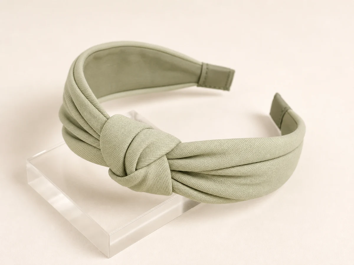 Pistachio cotton twill padded headband with a restrained low knot and controlled pleats