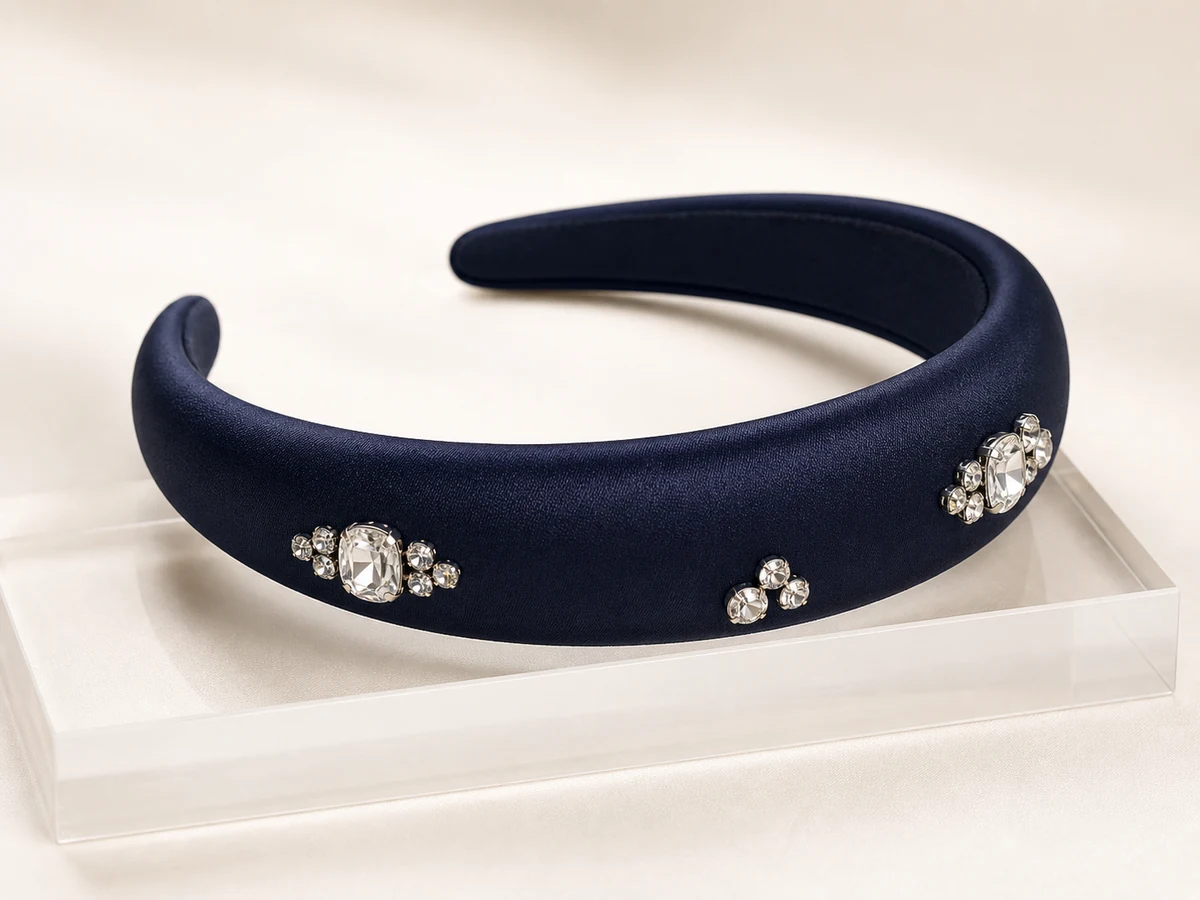 Midnight navy satin padded headband with restrained clear crystal constellations in silver-tone settings