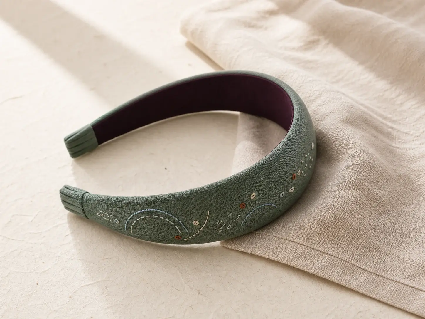 concept muted jade padded headband with abstract hand-finished embroidery